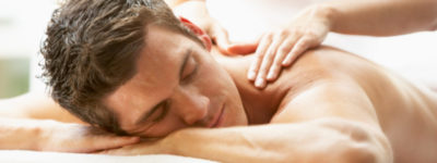 Young Man Enjoying Massage At Spa Young Man Enjoying Massage At Spa